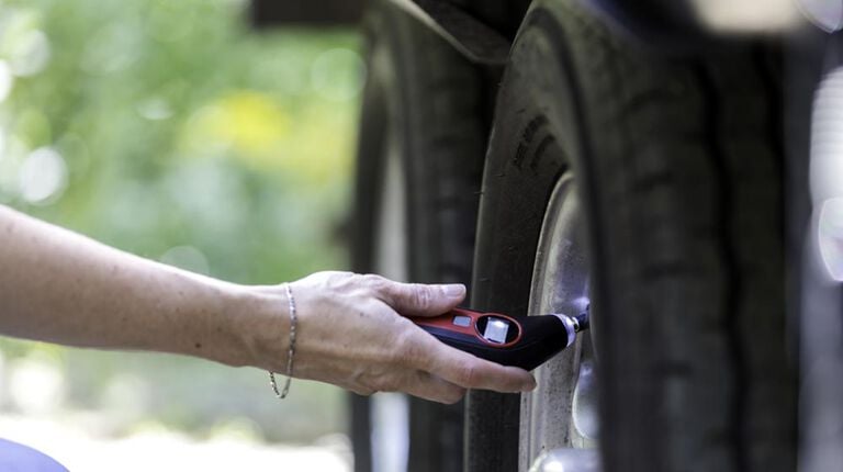 Checking tire pressure on a trailer