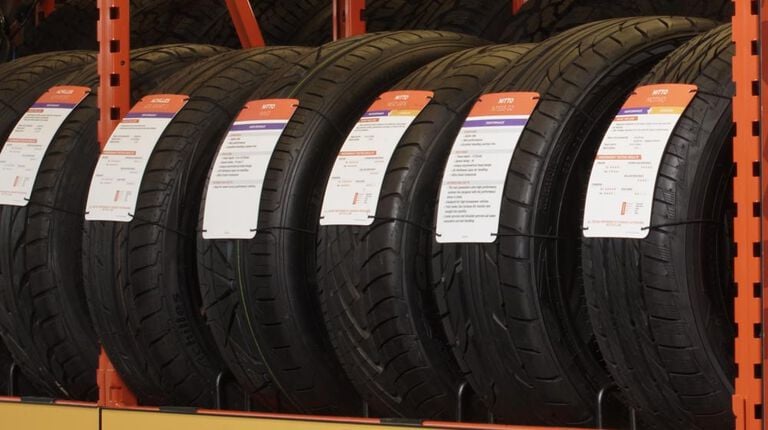 What’s the difference between directional, asymmetrical & symmetrical tread patterns? Tires in tire rack with directional tires rotation pattern