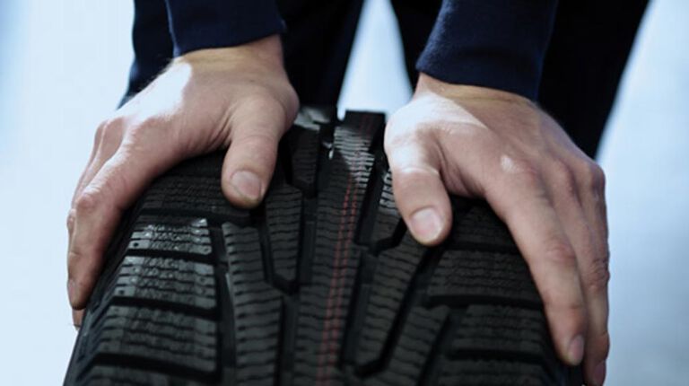 Kal Tire team member inspecting tire