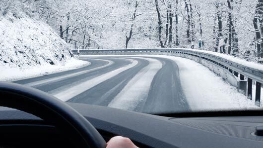 Car driving safely on winter road