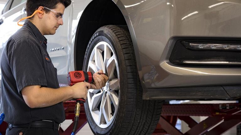 Kal Tire team member rotating tires