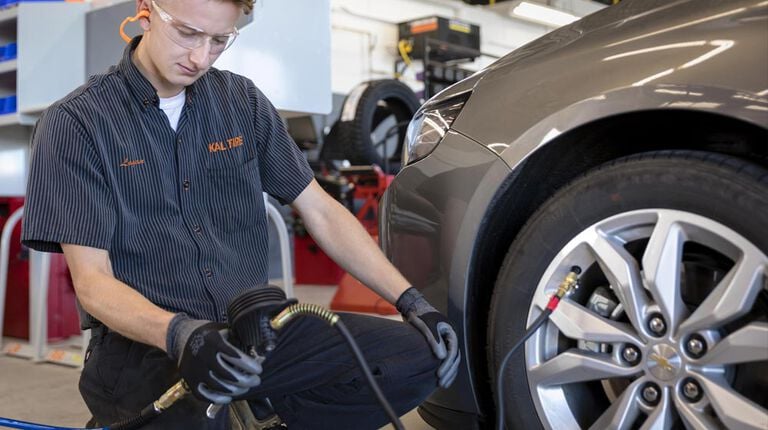 How to check tire pressure: A 5-step guide Kal Tire team member checking tire pressure