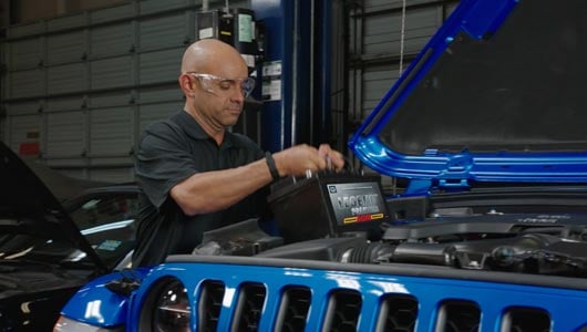 Kal Tire team member changing battery