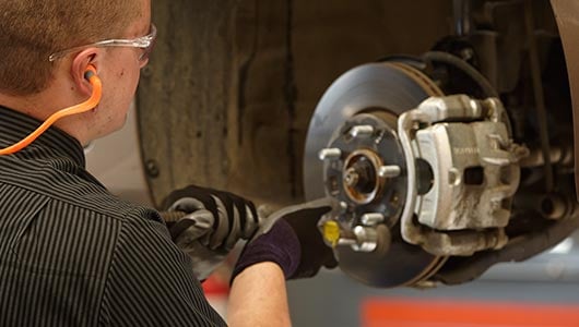 Kal Tire team member servicing brakes