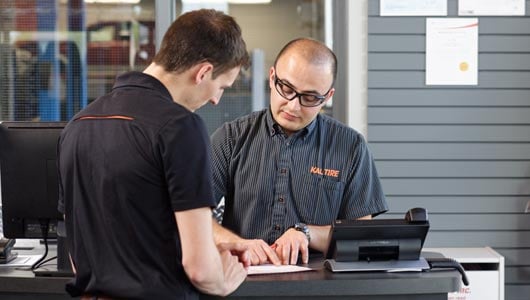 Kal Tire team member explaining brake check