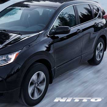 Vehicle driving on road with Nitto tires. Nitto tire special