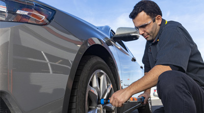 Kal Tire team member working on vehicle