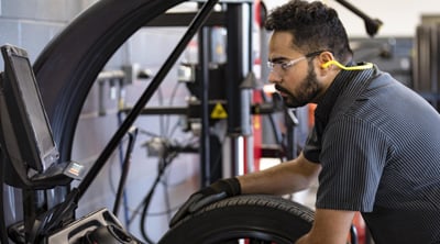 Kal Tire team member changing tire